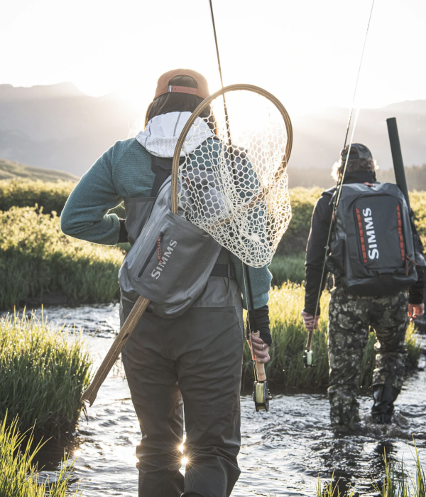 Submersible Simms Dry Creek Z Sling Pack, designed for dry and secure fishing gear storage.